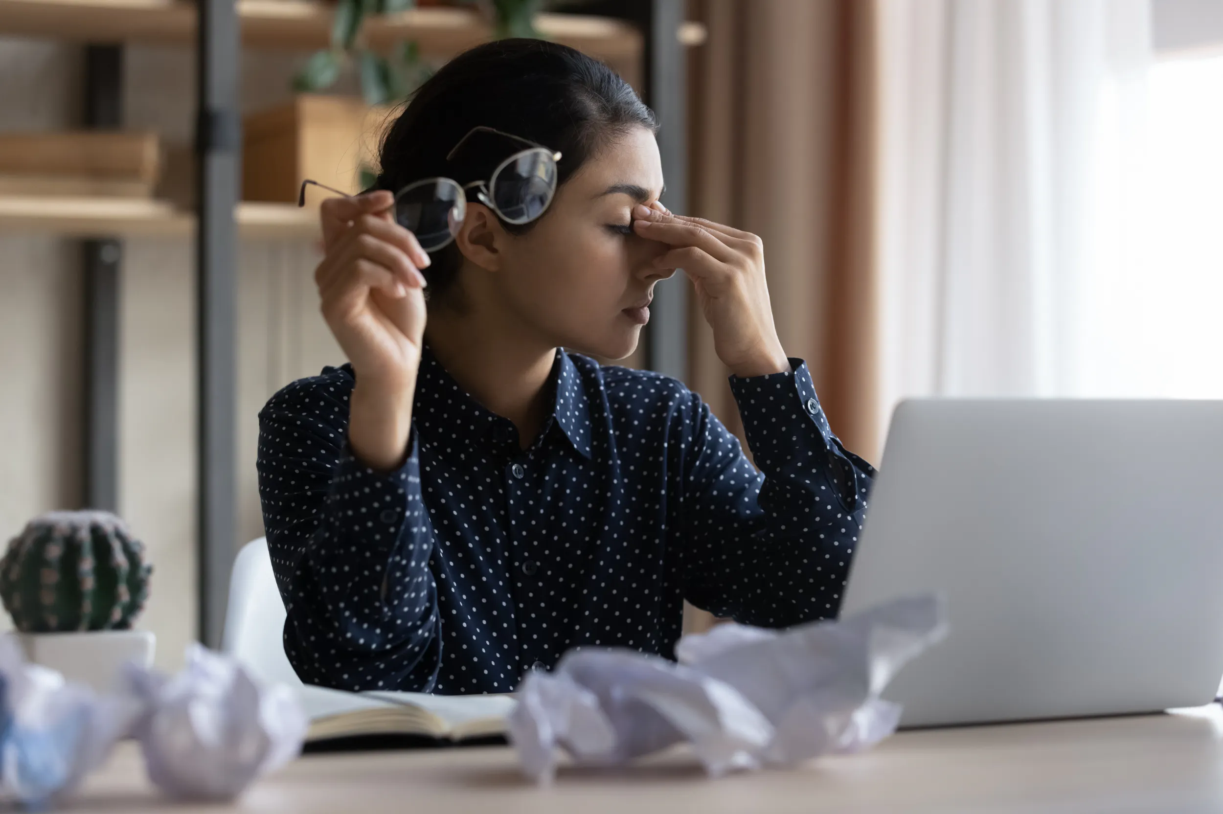 Frustrated business women with crumpled paper from mistakes